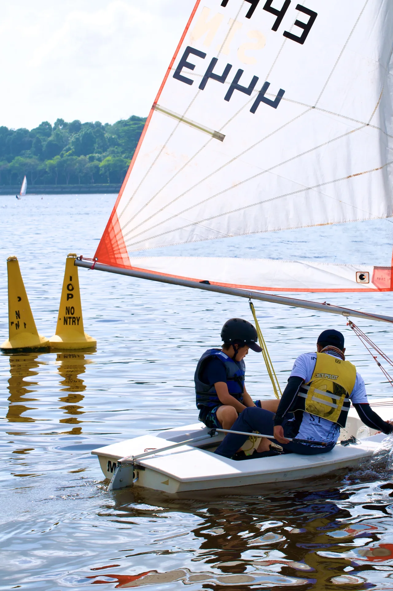 SeaQuest sailors learning to handle a dinghy on the Johor water