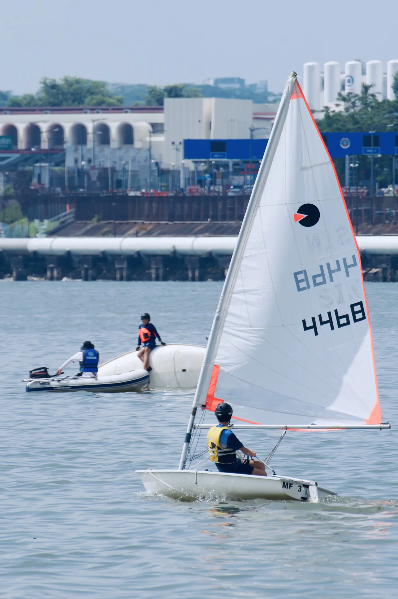 A SeaQuest dinghy sailor practising on the water