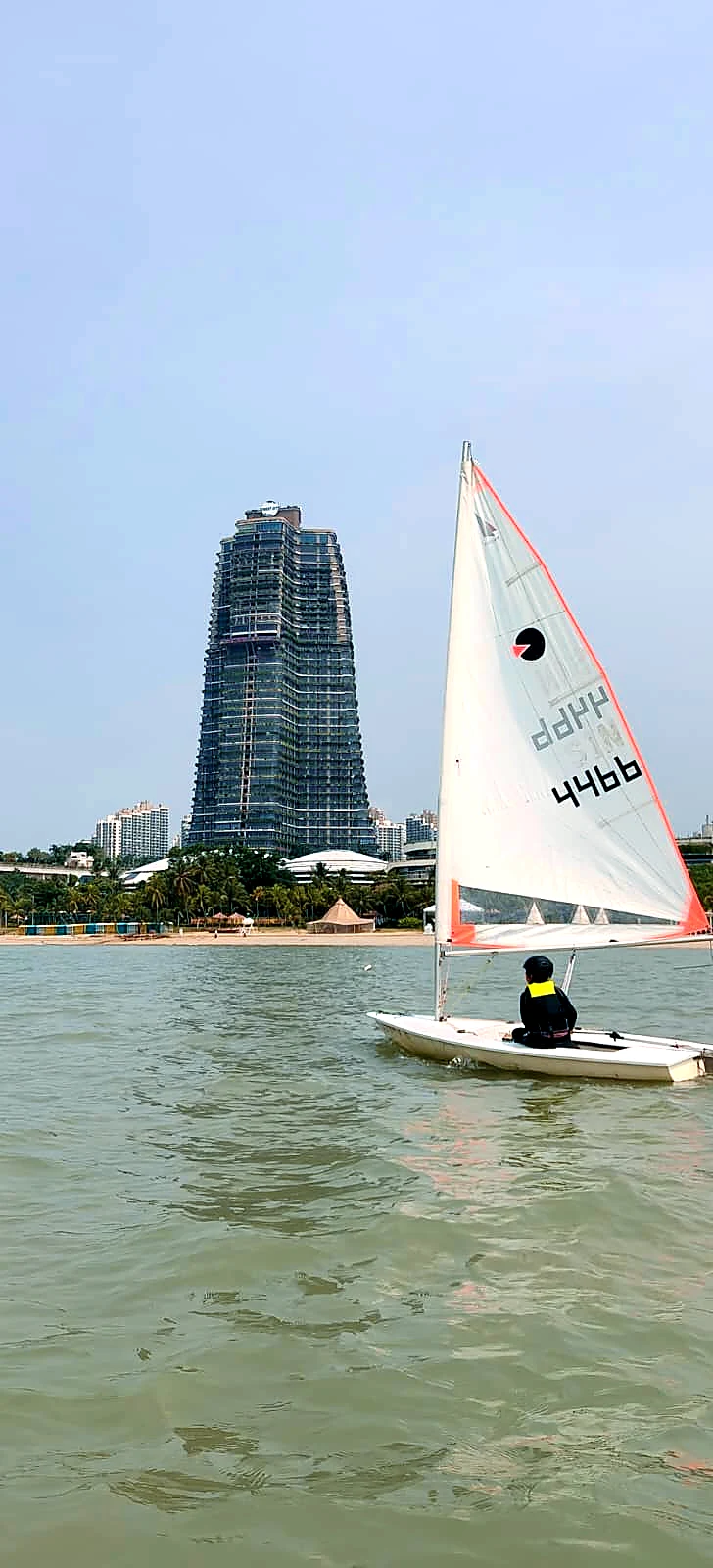 A SeaQuest dinghy sailing in front of the Forest City waterfront