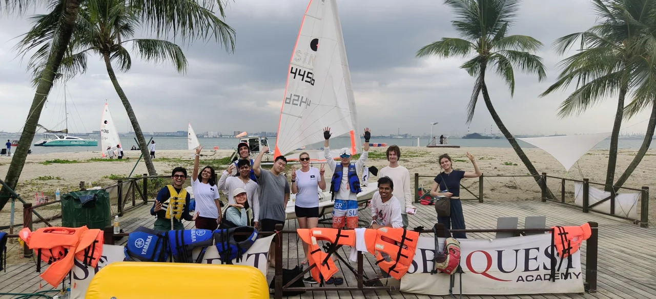 SeaQuest students with their sailing equipment and academy banner