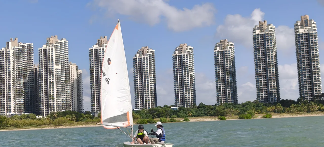 SeaQuest dinghy sailing in front of the Forest City waterfront