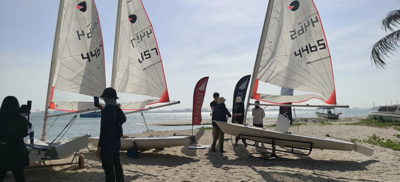 SeaQuest dinghies lined up on the sand before sailing